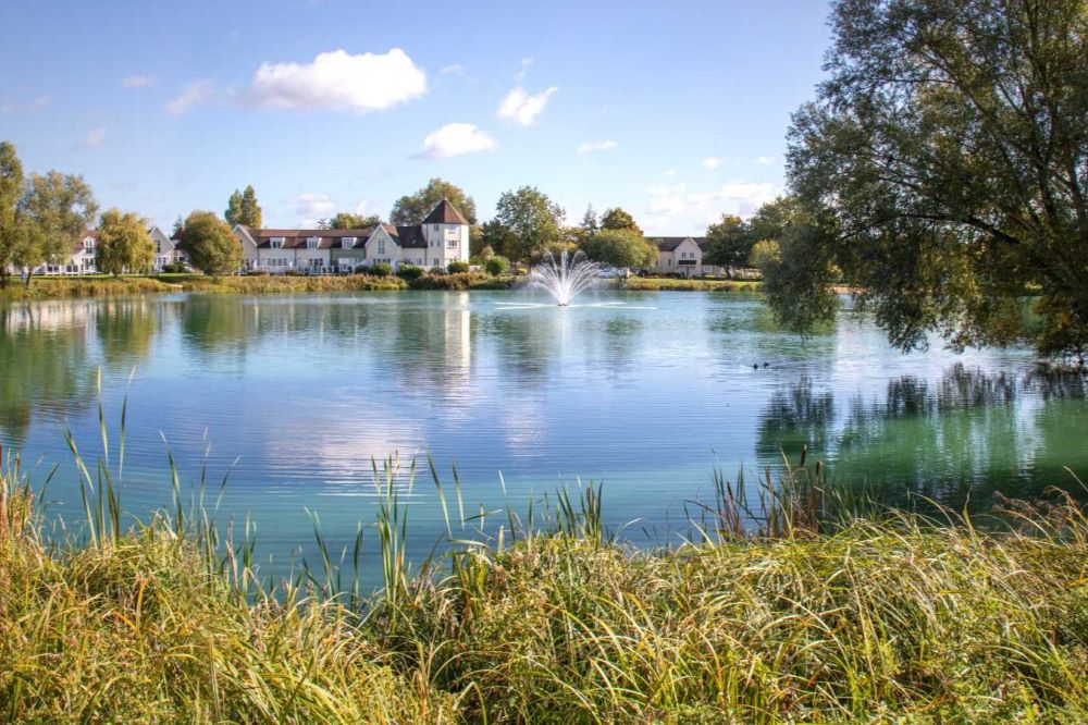 Looking across Windrush lake to the fountain and some of the properties